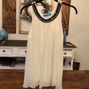 Ivory colored flowy top with black beading